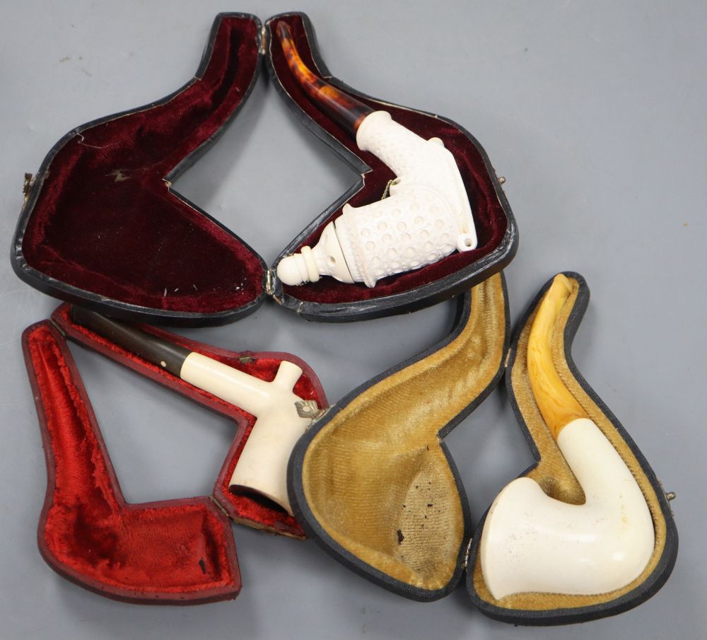 Three Meerschaum pipes, cased